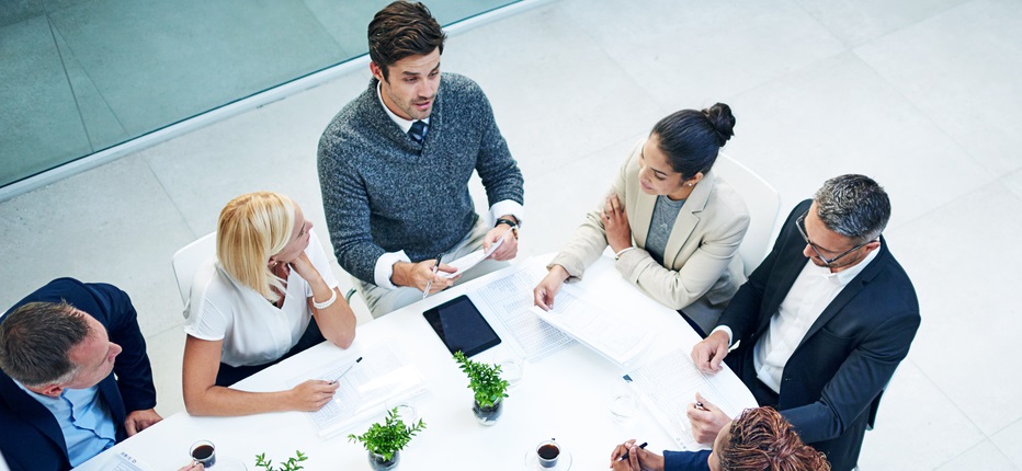 High angle shot of a group of businesspeople sitting in a meeting